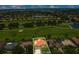 An aerial view of a single-Gathering home with a red tile roof, a screened-in pool, and access to a golf course at 2388 Baronsmede Ct, Winter Garden, FL 34787