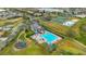 An aerial view of the neighborhood featuring the pool, clubhouse, sports courts and playground at 2388 Baronsmede Ct, Winter Garden, FL 34787