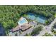 Aerial view of community pool and tennis courts surrounded by lush forest and convenient parking at 2388 Baronsmede Ct, Winter Garden, FL 34787