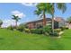 Beautiful backyard featuring lush green lawn, mature landscaping, and screened-in patio at 2388 Baronsmede Ct, Winter Garden, FL 34787