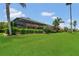 Expansive backyard showcases mature trees, manicured hedges, and enclosed lanai at 2388 Baronsmede Ct, Winter Garden, FL 34787