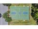 Aerial view of outdoor basketball court surrounded by trees, with nearby seating and parking at 2388 Baronsmede Ct, Winter Garden, FL 34787