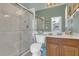 Well-lit bathroom with double vanity sink and glass enclosed walk-in shower at 2388 Baronsmede Ct, Winter Garden, FL 34787