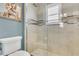 Updated bathroom featuring glass enclosed shower, tiled walls, and neutral decor at 2388 Baronsmede Ct, Winter Garden, FL 34787