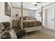 Bedroom featuring a four-poster bed, neutral walls and carpet, and shuttered windows at 2388 Baronsmede Ct, Winter Garden, FL 34787
