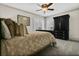 Bedroom featuring a neutral palette, shuttered windows, and a large dark-colored wardrobe at 2388 Baronsmede Ct, Winter Garden, FL 34787