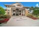 The entrance to the Stoneybrook West Town Center Clubhouse with an arched entryway and stone accents at 2388 Baronsmede Ct, Winter Garden, FL 34787