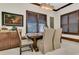 Cozy dining area features shuttered windows, artwork and a wooden table with upholstered chairs at 2388 Baronsmede Ct, Winter Garden, FL 34787