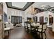 Open dining area with hardwood floors, chandelier, and staircase, flowing into a comfortable living space at 2388 Baronsmede Ct, Winter Garden, FL 34787