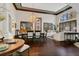 Elegant dining area features hardwood floors, high ceilings, and a chandelier, adjacent to the living room at 2388 Baronsmede Ct, Winter Garden, FL 34787