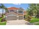 Beautiful two-story home featuring a three-car garage, paver driveway, and lush landscaping at 2388 Baronsmede Ct, Winter Garden, FL 34787