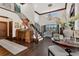 Grand foyer featuring high ceilings, dark wood floors, and an elegant staircase with iron railings at 2388 Baronsmede Ct, Winter Garden, FL 34787