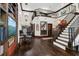 Spacious entry featuring hardwood floors, staircase with iron railings, and a stylish chandelier at 2388 Baronsmede Ct, Winter Garden, FL 34787