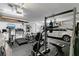 Garage converted into a home gym, with machines, weights, and ample space at 2388 Baronsmede Ct, Winter Garden, FL 34787