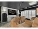 Home theater with plush seating, projector screen, and window shutters at 2388 Baronsmede Ct, Winter Garden, FL 34787