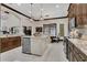 This kitchen features granite countertops, stainless appliances, a center island and adjacent dining area at 2388 Baronsmede Ct, Winter Garden, FL 34787