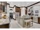This kitchen features granite countertops, stainless appliances, a center island with seating, and staircase access at 2388 Baronsmede Ct, Winter Garden, FL 34787