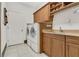 Bright laundry room with washer, dryer, cabinets, and countertop space at 2388 Baronsmede Ct, Winter Garden, FL 34787
