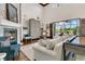 Bright living room with a stone fireplace, high ceilings, and views of the outdoor pool area at 2388 Baronsmede Ct, Winter Garden, FL 34787