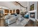 Open-concept living area with a stone fireplace, high ceilings, and dark hardwood floors at 2388 Baronsmede Ct, Winter Garden, FL 34787