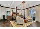 The spacious main bedroom features a tray ceiling, hardwood floors, and access to a private balcony at 2388 Baronsmede Ct, Winter Garden, FL 34787