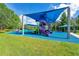 Vibrant and fun playground featuring colorful slides, climbing structures, and shaded seating areas at 2388 Baronsmede Ct, Winter Garden, FL 34787