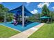 Vibrant and shaded playground with slides, climbing structures, and a picnic area, perfect for Gathering fun at 2388 Baronsmede Ct, Winter Garden, FL 34787