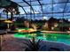Enclosed pool area with underwater lighting, bar and tiled floor overlooking the golf course at 2388 Baronsmede Ct, Winter Garden, FL 34787