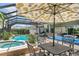 Screened-in lanai with pool, spa, outdoor kitchen, and seating area at 2388 Baronsmede Ct, Winter Garden, FL 34787