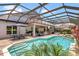 Outdoor oasis with pool, spa, dining, seating, outdoor kitchen under screened lanai at 2388 Baronsmede Ct, Winter Garden, FL 34787