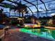 Enclosed pool area with tile flooring, underwater lighting and bar, perfect for evening relaxation and entertainment at 2388 Baronsmede Ct, Winter Garden, FL 34787