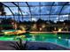 Enclosed pool area with underwater lighting and golf course views, creating a serene and luxurious backyard retreat at 2388 Baronsmede Ct, Winter Garden, FL 34787