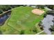 Aerial view of a well-maintained soccer field with goals, a baseball diamond, and ample parking at 2388 Baronsmede Ct, Winter Garden, FL 34787