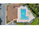 Aerial view of large community swimming pool with chairs, umbrellas, and ample deck space at 2388 Baronsmede Ct, Winter Garden, FL 34787