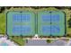 Aerial view of four tennis courts with manicured green surroundings and parking area at 2388 Baronsmede Ct, Winter Garden, FL 34787