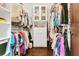 Walk-in closet with custom shelving and drawers provides ample storage space at 2388 Baronsmede Ct, Winter Garden, FL 34787