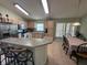 Cozy eat-in kitchen with breakfast bar, stainless steel appliances, and tile flooring at 2515 La Jolla Trl, Kissimmee, FL 34747