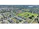 A high-angle aerial view showcases a residential neighborhood with cozy houses and community space at 264 Milestone Dr, Haines City, FL 33844