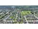 Aerial view showcases neighborhood homes, and community grounds with a lake visible in the distance at 264 Milestone Dr, Haines City, FL 33844