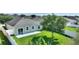 Spacious backyard with a white fence, lush green grass, and a sliding glass door leading inside at 264 Milestone Dr, Haines City, FL 33844