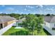 Expansive backyard with vibrant green grass, white fencing, and a sliding glass door entering the home at 264 Milestone Dr, Haines City, FL 33844