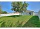 Spacious backyard featuring manicured lawn, privacy fence, and mature landscaping at 264 Milestone Dr, Haines City, FL 33844