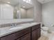 Bathroom with double vanity featuring granite countertops, a large mirror, and modern fixtures at 264 Milestone Dr, Haines City, FL 33844
