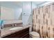 Bright bathroom featuring a vanity with granite countertop, tiled backsplash, and patterned shower curtain at 264 Milestone Dr, Haines City, FL 33844
