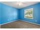Bright bedroom featuring carpeting, a ceiling fan, and a large window offering natural light at 264 Milestone Dr, Haines City, FL 33844