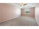 Cozy bedroom featuring neutral carpeting, a ceiling fan, and a window with natural light at 264 Milestone Dr, Haines City, FL 33844