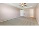 Large bedroom with a tray ceiling, carpeting, and access to an ensuite bathroom and walk-in closet at 264 Milestone Dr, Haines City, FL 33844