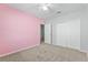 Neutral bedroom with a ceiling fan, carpet, and a double door closet offers ample space for rest and relaxation at 264 Milestone Dr, Haines City, FL 33844
