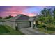 Charming single-story home featuring a two-car garage, manicured lawn, and lovely landscaping at 264 Milestone Dr, Haines City, FL 33844