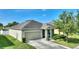 Well-maintained single-story home with a two-car garage and landscaped front yard at 264 Milestone Dr, Haines City, FL 33844